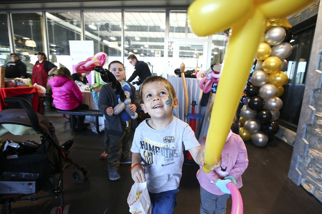 Three-year-old Aidan Cahow holds up a balloon during the second annual "Silver and Gold" food drive at City National Arena in Las Vegas on Thursday, Nov. 15, 2018. Chase Stevens Las Vega ...