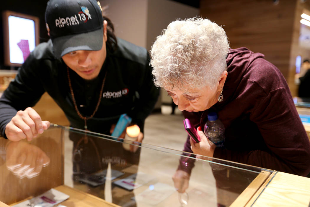 Barbara Strecker of Las Vegas checks out product with the help of budtender Brandon Hang at Planet 13, which bills itself as one of the largest dispensaries in the world, Thursday, Nov. 1, 2018. T ...