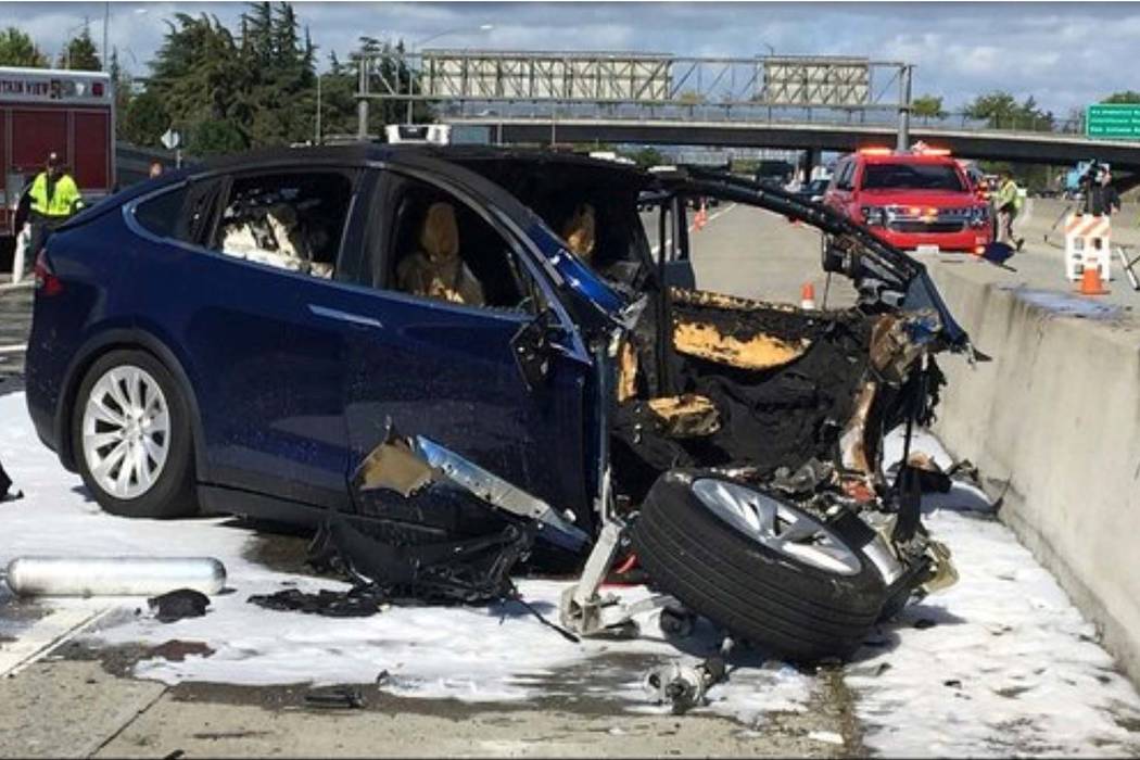 Emergency personnel work a the scene where a Tesla electric SUV crashed into a barrier on U.S. Highway 101 in Mountain View, Calif., March 23, 2018. The test results by AAA released Thursday, Nov. ...