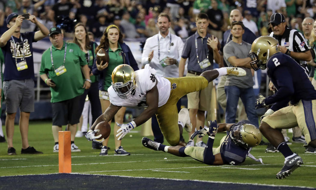 FILE - In this Oct. 27, 2018, file photo, Notre Dame running back Dexter Williams leaps into the end zone for a touchdown during the first half of an NCAA college football game against Navy in San ...