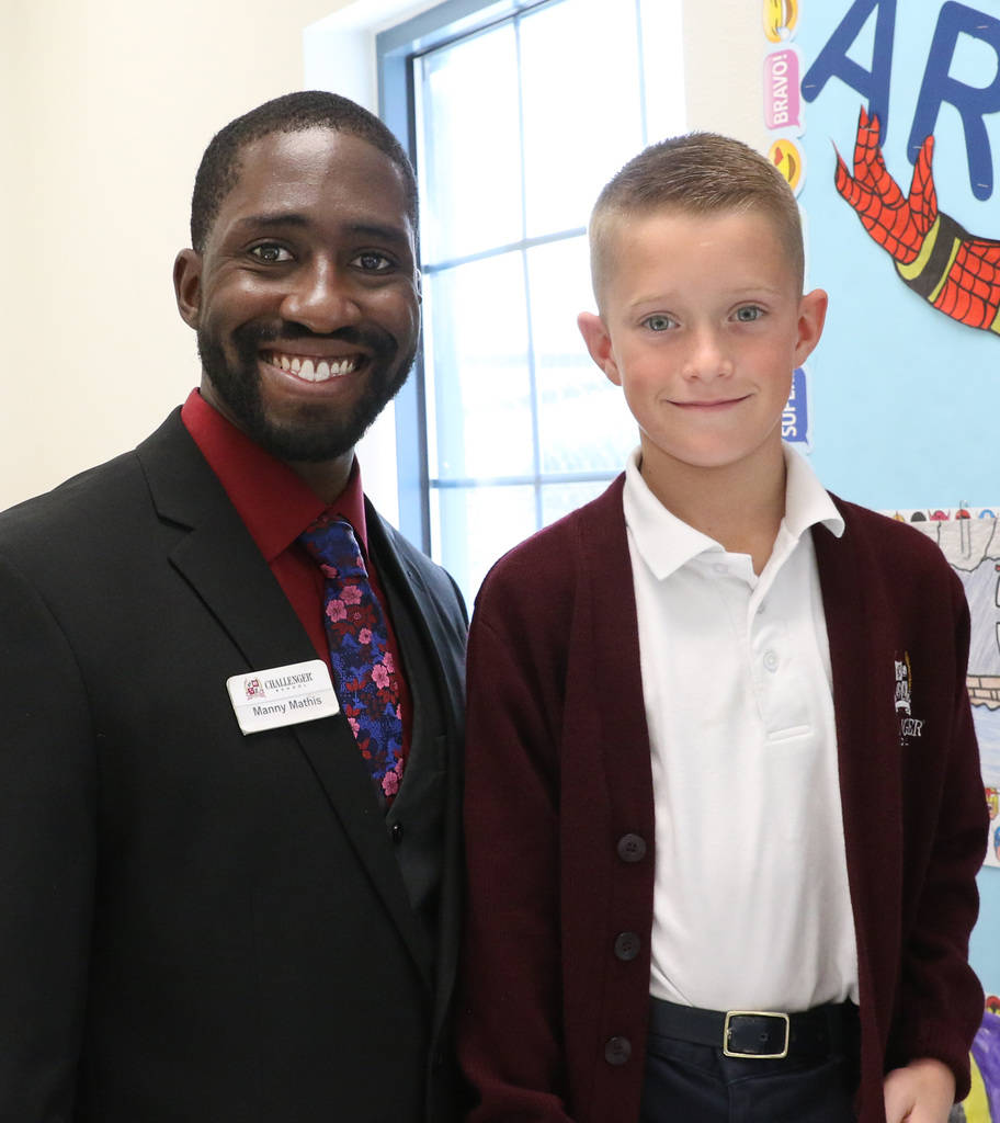 Manuel Mathis, a 2nd-grade teacher at Challenger School-Silverado campus, poses for a photo with his student Carson Redford on Friday, Nov. 16, 2018, in Las Vegas. Mathis won a national Crayola cr ...