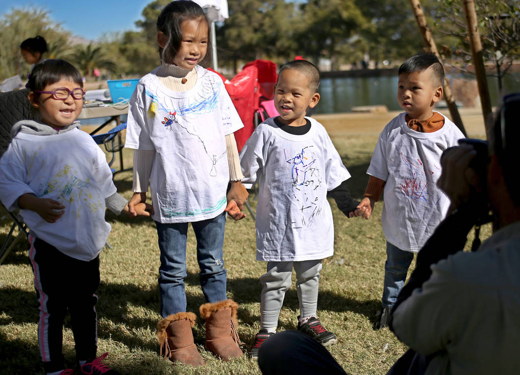 Josephine Huang, 4, from left, her cousin Adelle Huang, 5, her brother Davin Huang, 3, and other cousin Aden Huang, 2, pose with their hand drawn t-shirts at Migratory Bird Day at Sunset Park in L ...