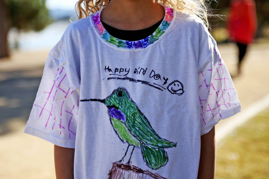 Jenna Hallmark, 9, shows off her hand drawn shirt at Migratory Bird Day at Sunset Park in Las Vegas, Sunday, Nov. 18, 2018. Different organizations offered activities for kids and adults to learn ...
