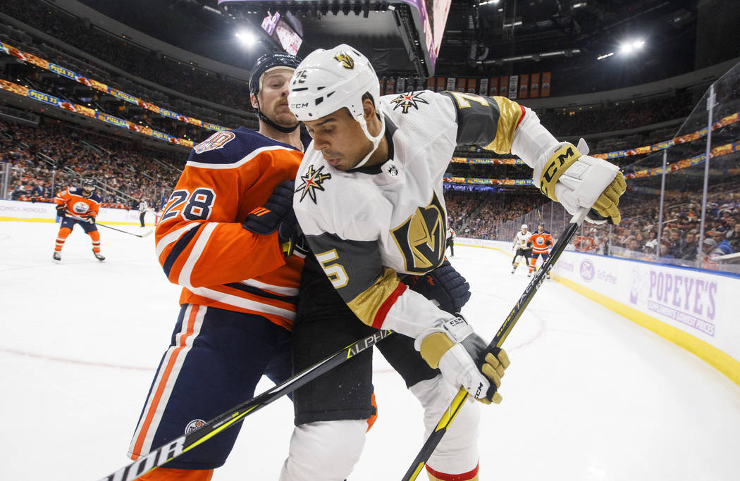 Vegas Golden Knights' Ryan Reaves (75) and Edmonton Oilers' Kyle Brodziak (28) battle in the corner during first period NHL hockey action in Edmonton, Alberta, on Sunday Nov. 18, 2018. (Jason Fran ...