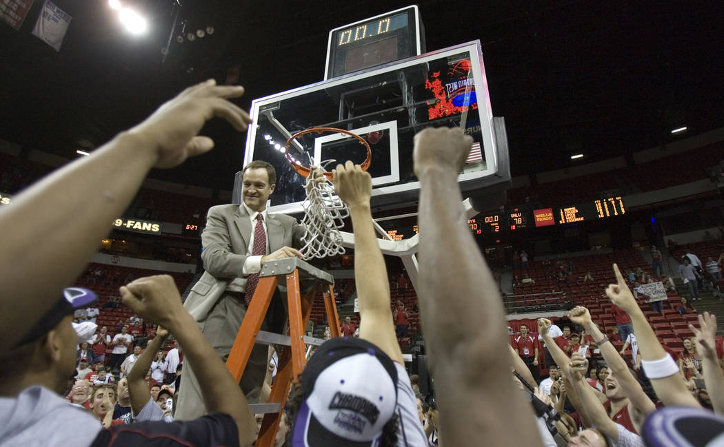 UNLV Head Coach Lon Kruger takes down the net after the Rebels' 78-70 victory over BYU in their Mountain West Conference Championship game at the Thomas & Mack Center Saturday, March 10, 2007. ...
