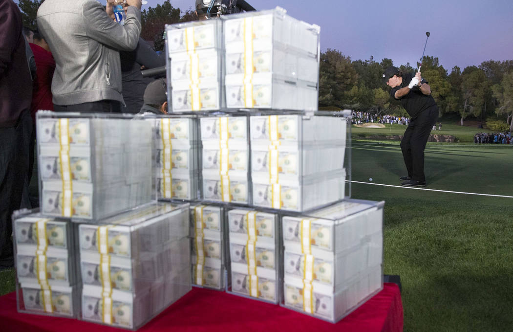 The $9 million prize is seen in the foreground as Phil Mickelson tees off before winning The Match at Shadow Creek Golf Course in North Las Vegas on Friday, Nov. 23, 2018. Richard Brian Las Vegas ...