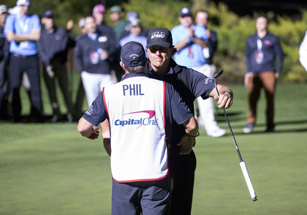 Phil Mickelson hugs his caddie after defeating Tiger Woods in The Match at Shadow Creek Golf Course in North Las Vegas on Friday, Nov. 23, 2018. Richard Brian Las Vegas Review-Journal @vegasphotograph