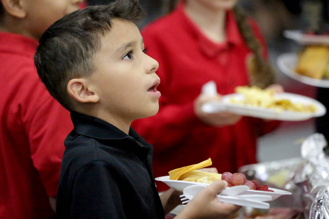 Angel Diaz, 8, fills his plate during a Thanksgiving potluck at Mountain View Christian School in Las Vegas on Friday, Nov. 16, 2018. Angel attends the school with help from the Opportunity Schola ...