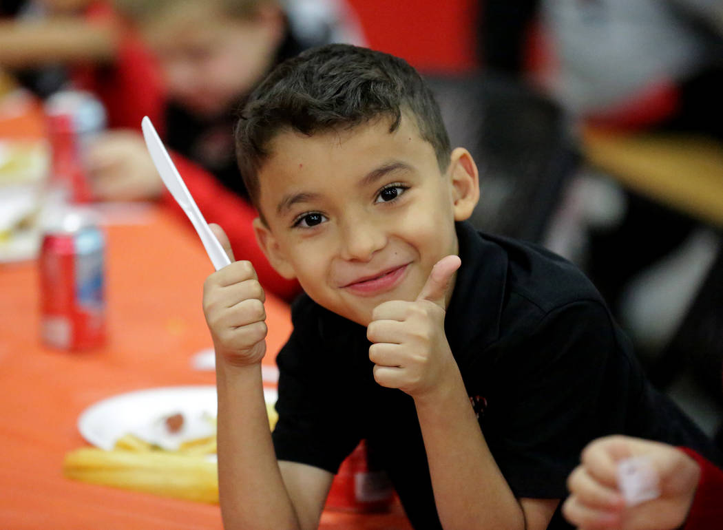 Angel Diaz, 8, gives two thumbs-up during a Thanksgiving potluck at Mountain View Christian School in Las Vegas on Friday, Nov. 16, 2018. Angel attends the school with help from the Opportunity Sc ...