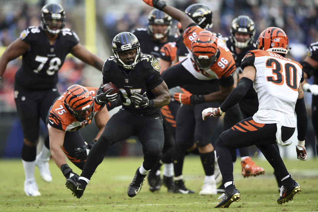 Baltimore Ravens running back Gus Edwards (35) rushes the ball in the second half of an NFL football game against the Cincinnati Bengals, Sunday, Nov. 18, 2018, in Baltimore. (AP Photo/Gail Burton)