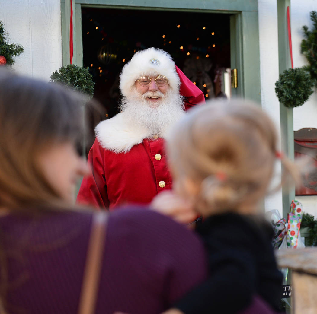 Santa Claus greets Henderson residents Monica Brodie and Emilia Brodie, 2, at the District at Green Valley Ranch in Henderson, Saturday, Nov. 24, 2018. Caroline Brehman/Las Vegas Review-Journal