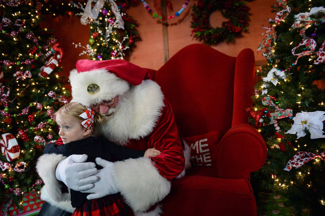 Emilia Brodie, 2, gives Santa Claus a hug at the District at Green Valley Ranch in Henderson, Saturday, Nov. 24, 2018. Caroline Brehman/Las Vegas Review-Journal