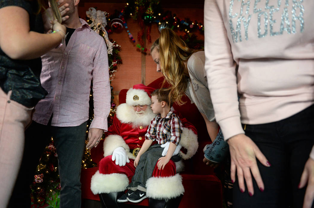 Maverick Willis, 5, from Henderson, sits on Santa Claus' lap at the District at Green Valley Ranch in Henderson, Saturday, Nov. 24, 2018. Caroline Brehman/Las Vegas Review-Journal