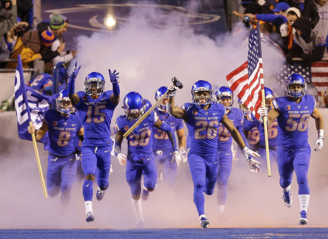 Boise State cornerback Avery Williams (26) carries the hammer as he leads Boise State on to the field before their matchup with Fresno State in an NCAA college football game, Friday, Nov. 9, 2018, ...