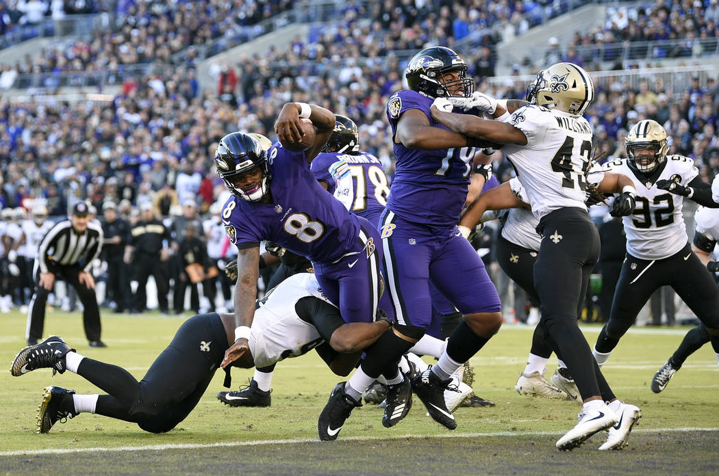 Baltimore Ravens quarterback Lamar Jackson (8) scores a touchdown in the first half of an NFL football game against the New Orleans Saints, Sunday, Oct. 21, 2018, in Baltimore. (AP Photo/Nick Wass)