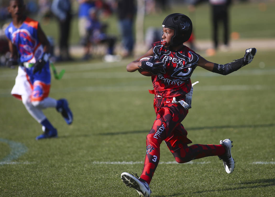 Apex Predators' Jett Washington runs the ball while playing against the Ballers during a National Youth Sports Nevada flag football game at Aventura Park in Henderson on Saturday, Nov. 17, 2018. C ...