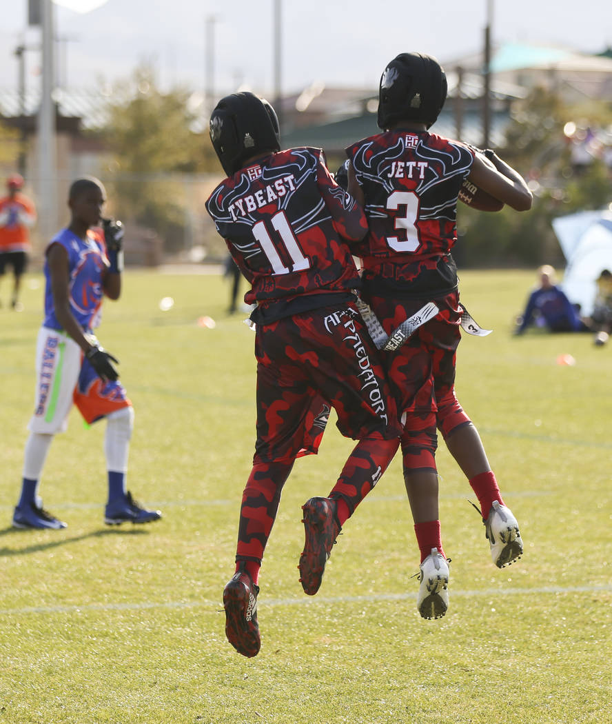 Apex Predators' Jett Washington (3) celebrates his touchdown with Tyrese Smith (11) while playing against the Ballers during a National Youth Sports Nevada flag football game at Aventura Park in H ...