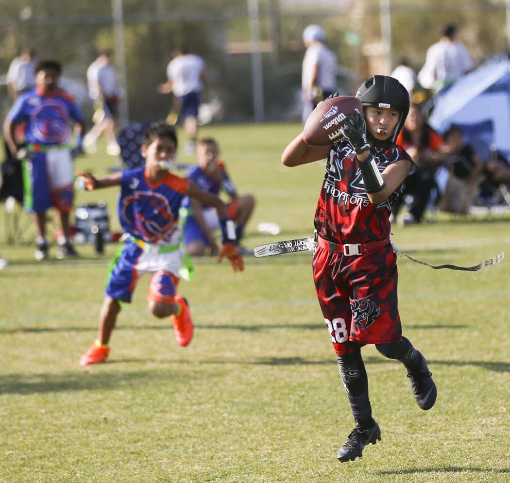 The Apex Predators' Seth Segovia pulls in a reception while playing against the Ballers during a National Youth Sports Nevada flag football game at Aventura Park in Henderson on Saturday, Nov. 17, ...