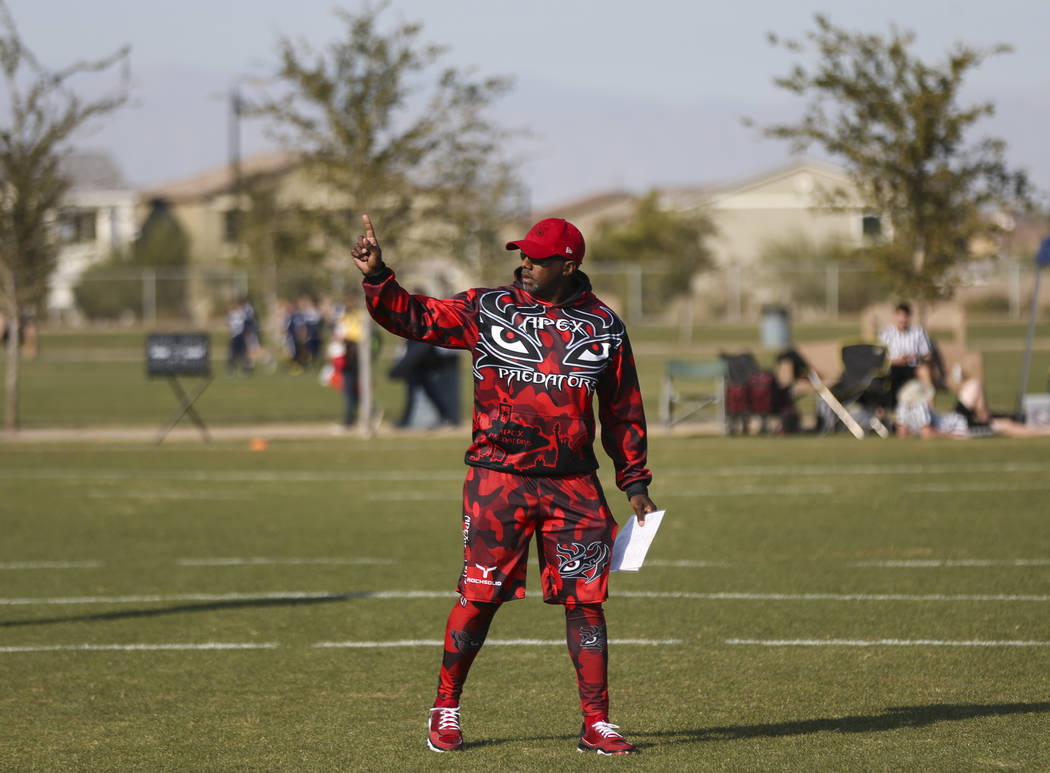 Apex Predators head coach Omar Smith motions to his team while playing against the Ballers during a National Youth Sports Nevada flag football game at Aventura Park in Henderson on Saturday, Nov. ...