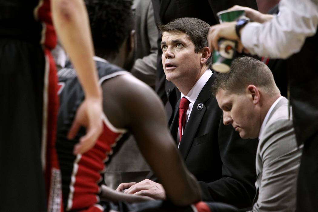 UNLV head coach Dave Rice talks to his players during a time out in the second half of their Mountain West Conference tournament quarterfinal game against San Diego State Thursday, March 12, 2015, ...