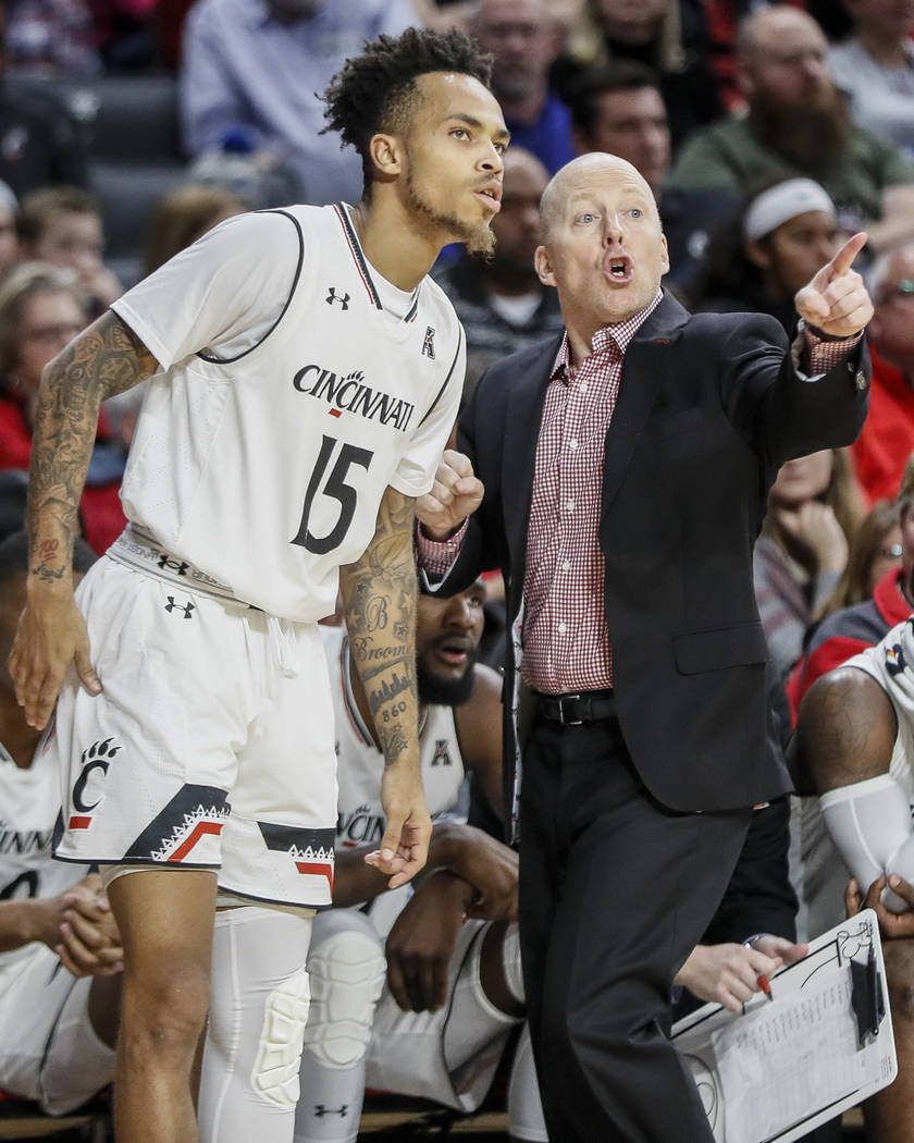 Cincinnati's head coach Mick Cronin, right, speaks with Cane Broome (15) in the second half of an NCAA college basketball game against Milwaukee, Friday, Nov. 16, 2018, in Cincinnati. (AP Photo/Jo ...