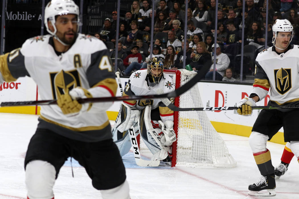 Vegas Golden Knights center Pierre-Edouard Bellemare (41) and defenseman Colin Miller (6) skate towards the action as goaltender Marc-Andre Fleury (29) defends the net during the second period aga ...