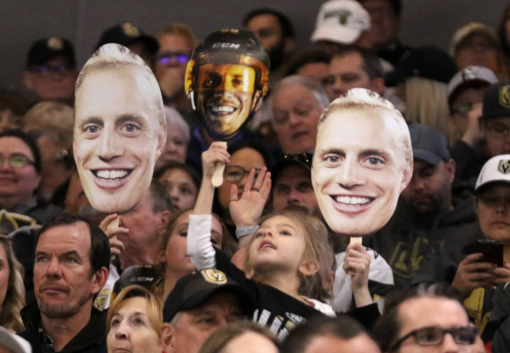 Vegas Golden Knights fans hold up faces of defenseman Nate Schmidt (88) to welcome him back in his first game back at the T-Mobile Arena during the first period of an NHL game against the Calgary ...