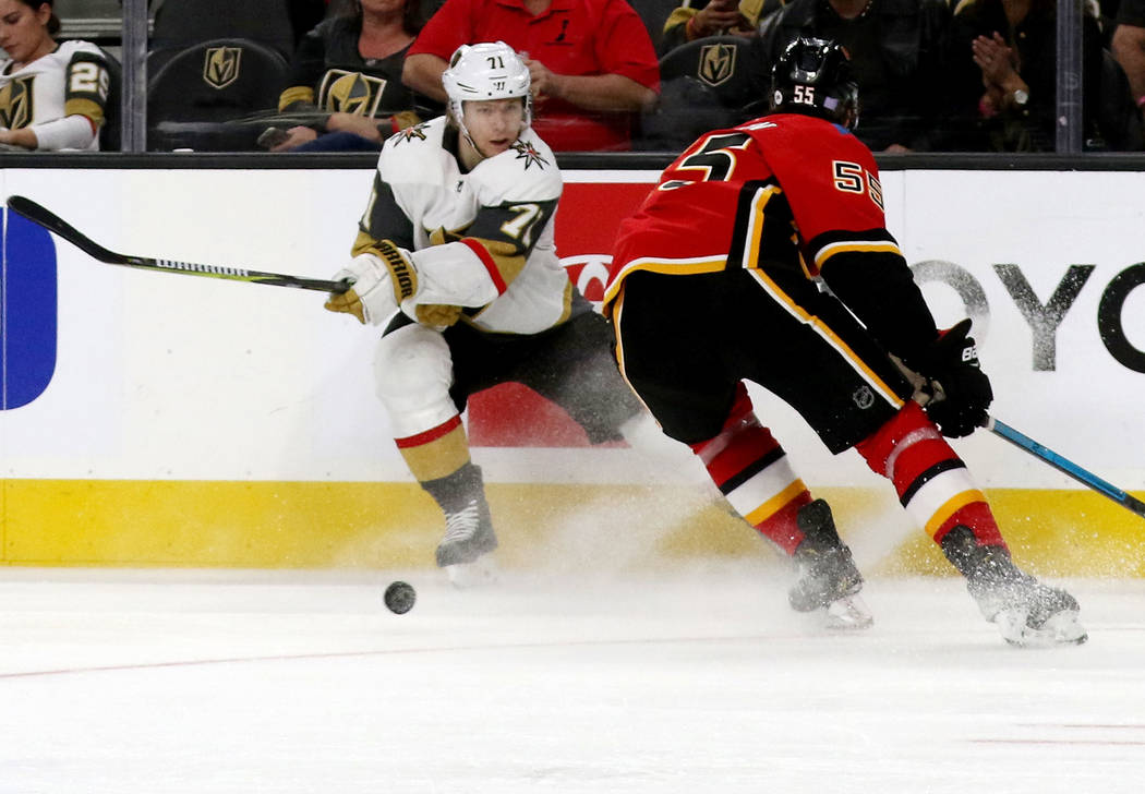 Vegas Golden Knights center William Karlsson (71) shoots the puck past Calgary Flames defenseman Noah Hanifin (55) during the third period of an NHL game in Las Vegas, Friday, Nov. 23, 2018. Heidi ...
