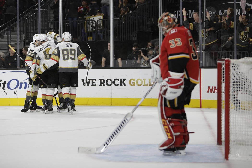 The Vegas Golden Knights celebrate after right wing Alex Tuch (89) scored a goal against the Calgary Flames during the second period of an NHL hockey game Friday, Nov. 23, 2018 in Las Vegas. (AP P ...