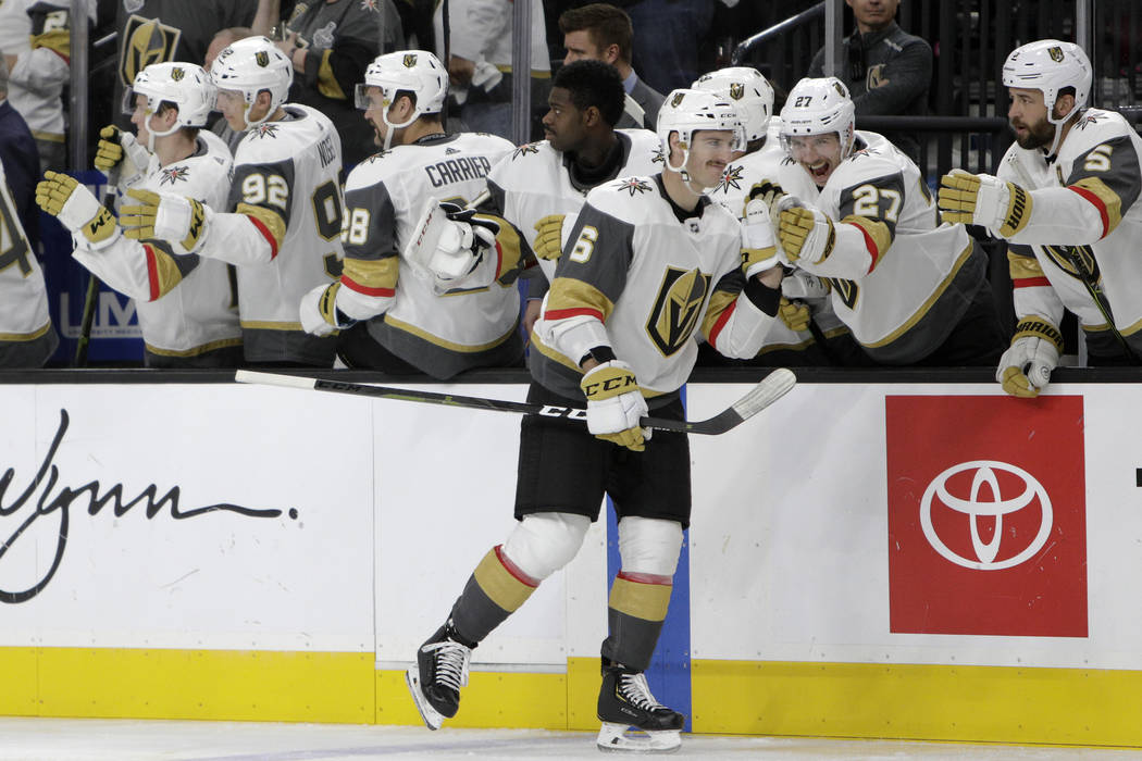 Vegas Golden Knights defenseman Colin Miller (6) is congratulated after scoring a goal during the third period of an NHL hockey game against the Calgary Flames Friday, Nov. 23, 2018 in Las Vegas. ...