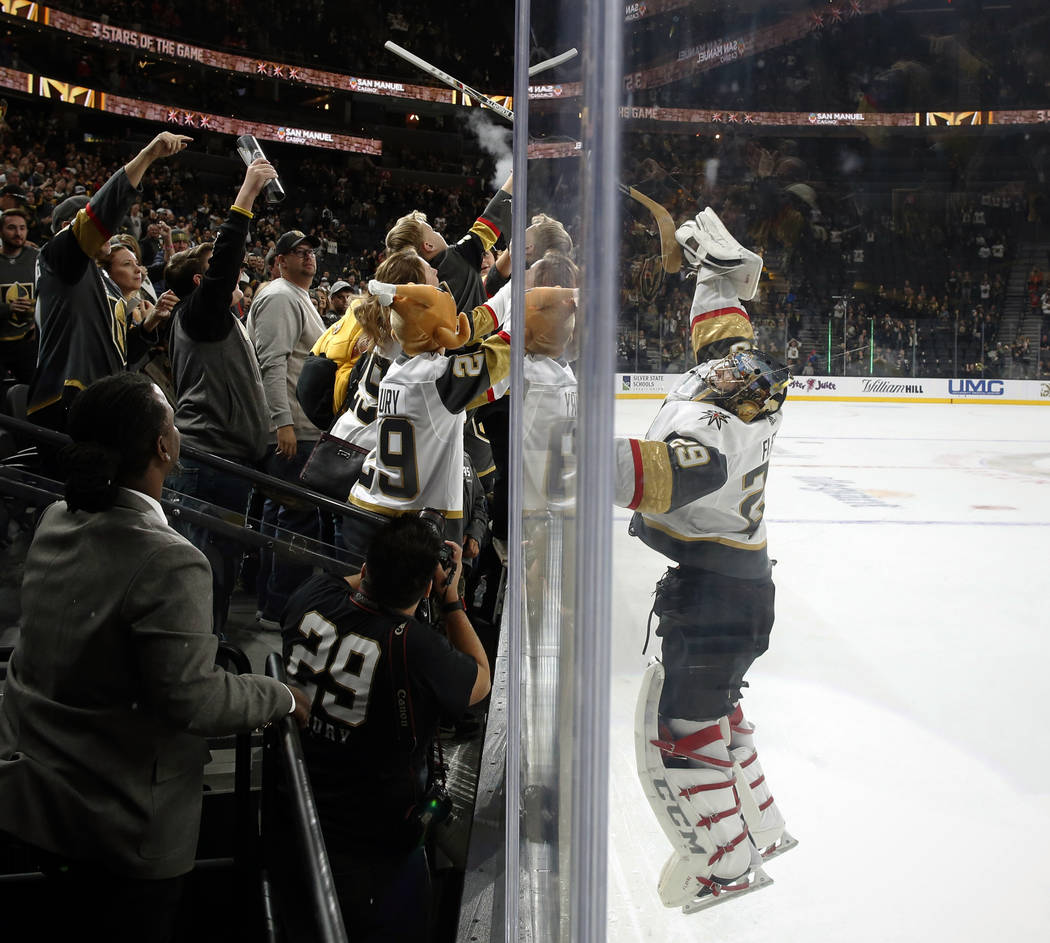 Vegas Golden Knights goaltender Marc-Andre Fleury (29) passes his stick to fans after shutting out the Calgary Flames during an NHL hockey game Friday, Nov. 23, 2018 in Las Vegas. (AP Photo/Joe Bu ...