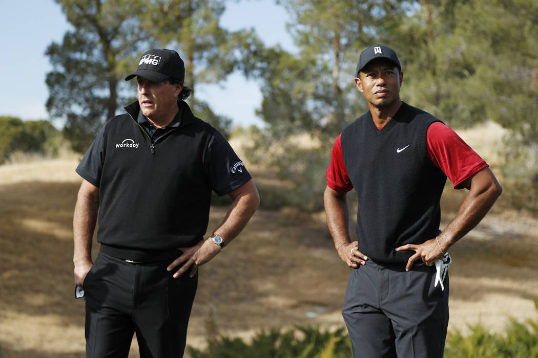 Phil Mickelson, left, and Tiger Woods stand at the first tee before a golf match at Shadow Creek golf course, Friday, Nov. 23, 2018, in Las Vegas. (AP Photo/John Locher)