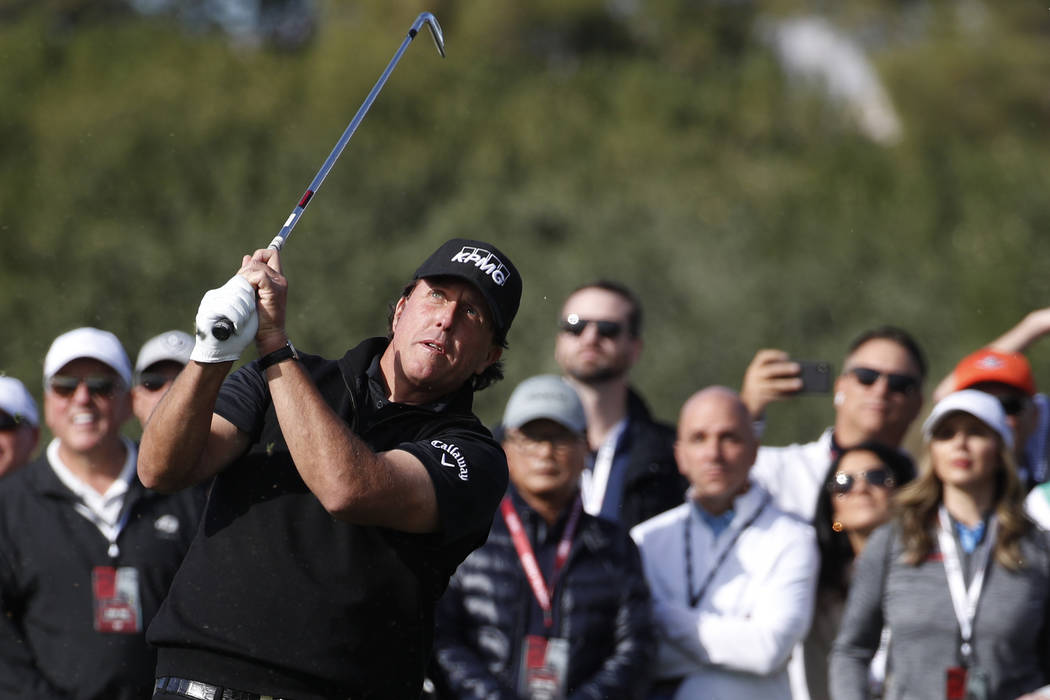 Phil Mickelson hits off the second fairway during a golf match against Tiger Woods at Shadow Creek golf course, Friday, Nov. 23, 2018, in Las Vegas. (AP Photo/John Locher)