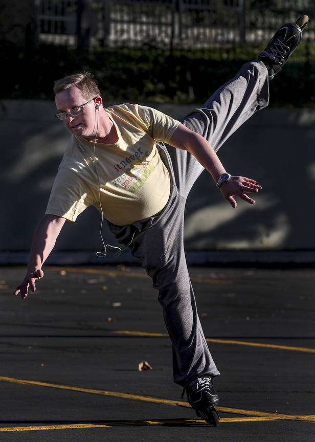 This photo taken Oct. 19, 2018, shows Reid Cornish gliding in an arc during his daily, morning in-line skating performance in downtown Salt Lake City on Friday, Oct. 19, 2018. Cornish, who has Dow ...