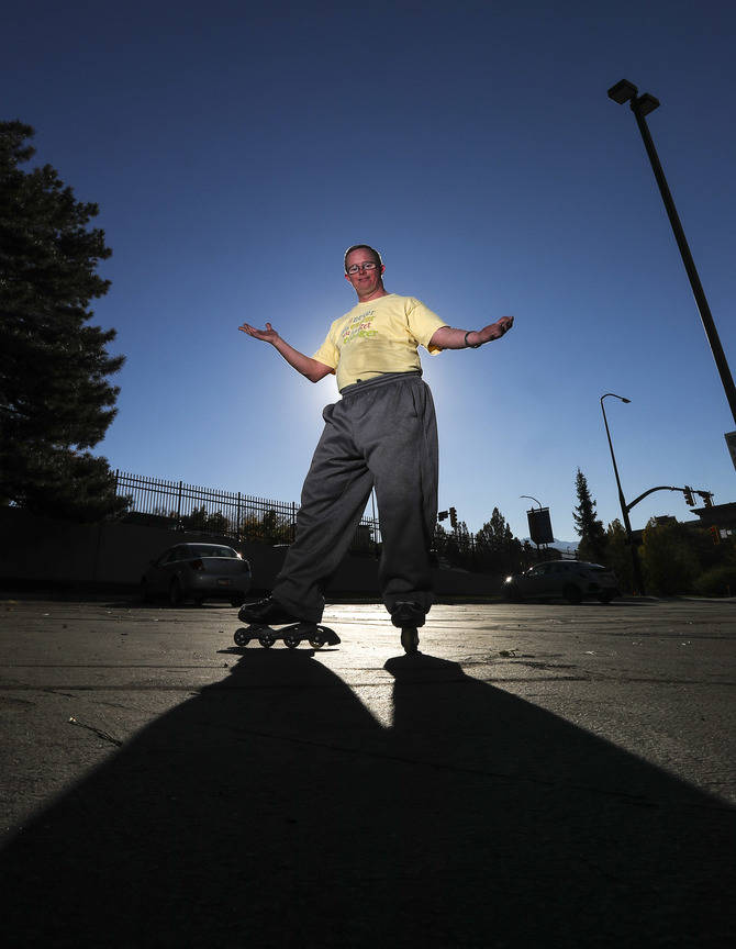 This photo taken Oct. 19, 2018, shows Reid Cornish posing for a portrait after finishing his daily, morning in-line skating performance in downtown Salt Lake City. Cornish, who has Down Syndrome, ...