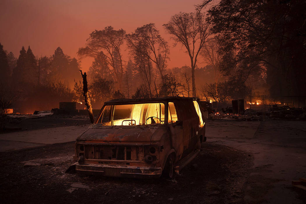 Flames burn inside a van as the Camp Fire tears through Paradise, Calif., on Nov. 8, 2018. (AP Photo/Noah Berger)
