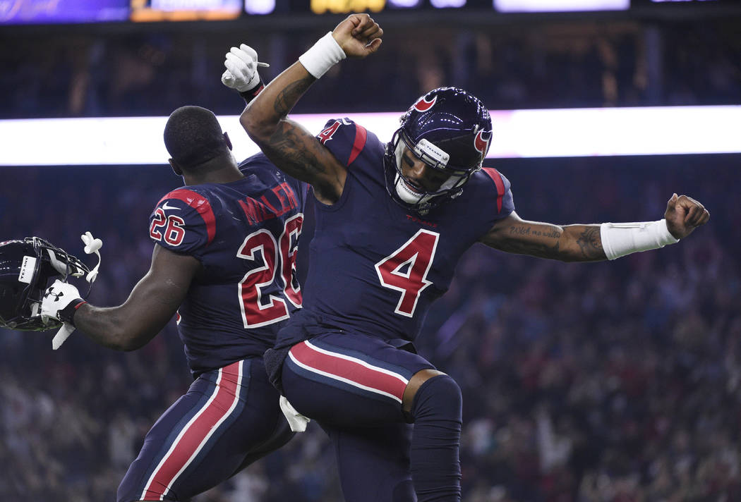 Houston Texans quarterback Deshaun Watson (4) and running back Lamar Miller (26) celebrate a touchdown against the Miami Dolphins during the first half of an NFL football game, Thursday, Oct. 25, ...