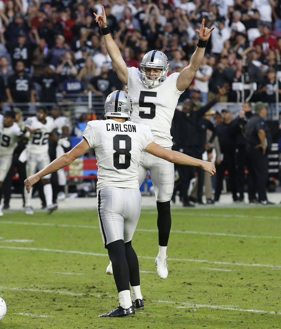 Oakland Raiders kicker Daniel Carlson (8) celebrates after kicking the game winning field goal with punter Johnny Townsend (5) during the second half of an NFL football game against the Arizona Ca ...
