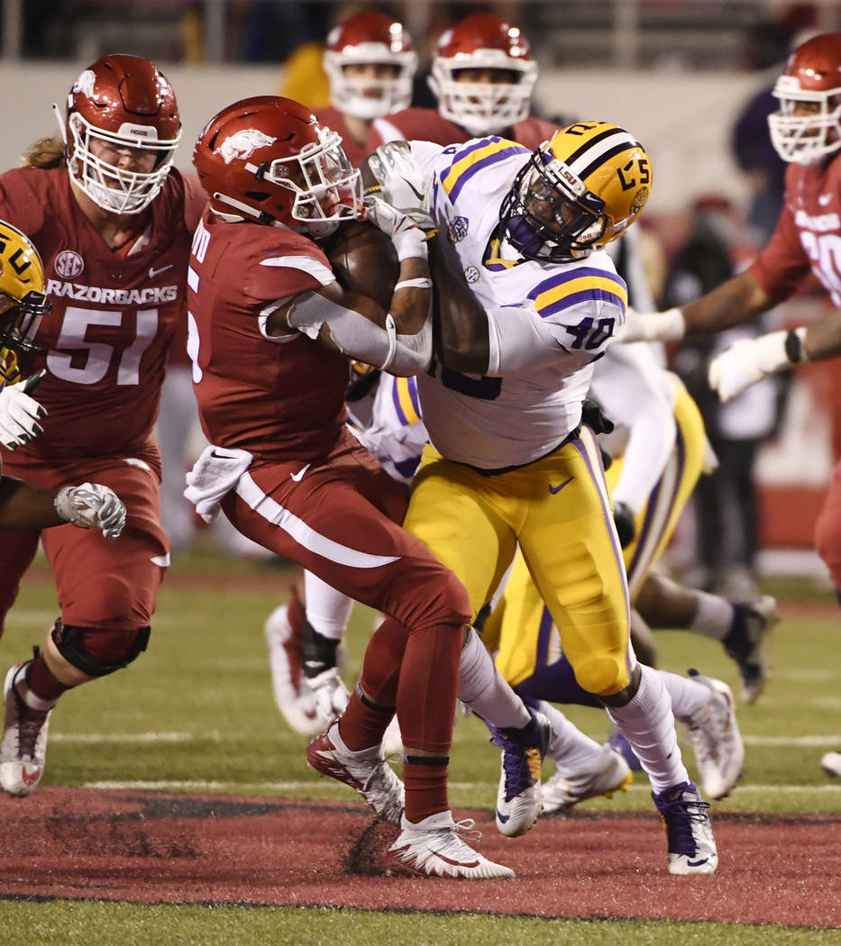 Arkansas running back Rakeem Boyd is tackled by LSU defender Devin White during the second half of an NCAA college football game, Saturday, Nov. 10, 2018, in Fayetteville, Ark. (AP Photo/Michael W ...