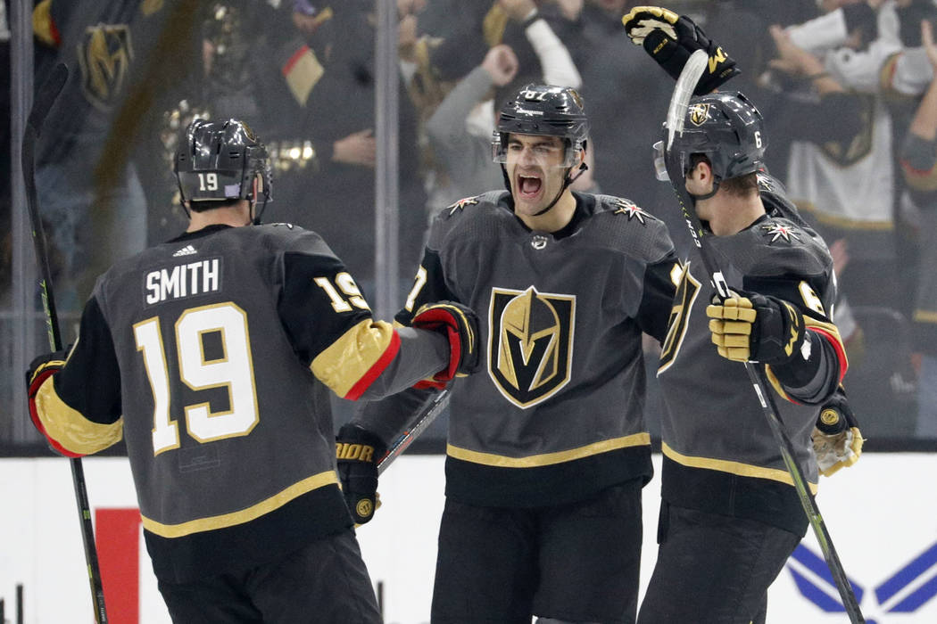 Vegas Golden Knights right wing Reilly Smith (19) and defenseman Colin Miller, right, celebrate after left wing Max Pacioretty, center, scored against the San Jose Sharks during the first period o ...