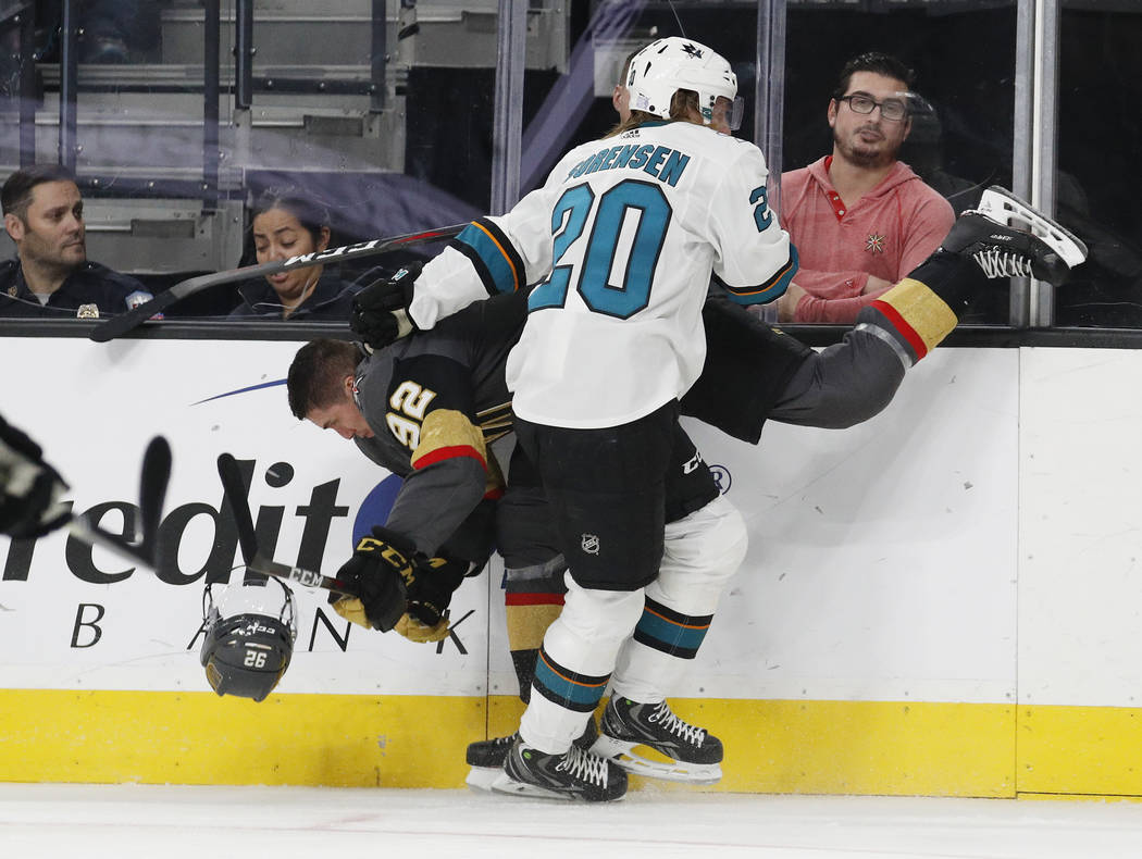 San Jose Sharks left wing Marcus Sorensen (20) checks Vegas Golden Knights left wing Tomas Nosek (92), who loses his helmet during the second period of an NHL hockey game Saturday, Nov. 24, 2018, ...