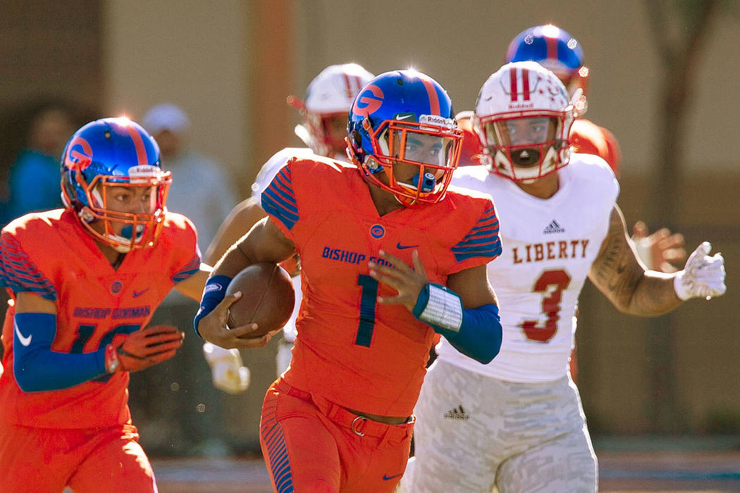 Bishop Gorman's Micah Bowens (1) breaks past Liberty defenders for a touchdown during the first half of the NIAA 4A Desert Region championship game at Bishop Gorman High School in Las Vegas on Sat ...