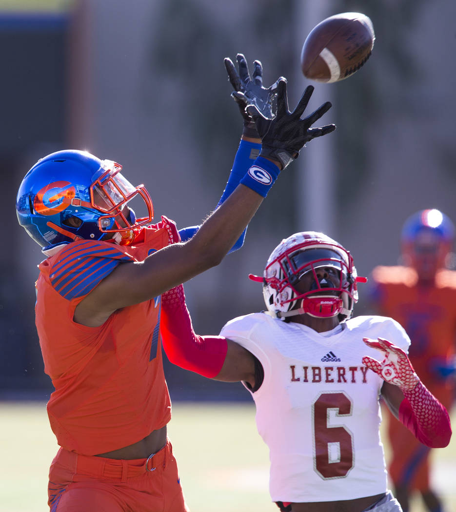Bishop Gorman's Donovan Smith (7) pulls in the ball over Liberty's Donte Bowers (6) during the first half of the NIAA 4A Desert Region championship game at Bishop Gorman High School in Las Vegas o ...