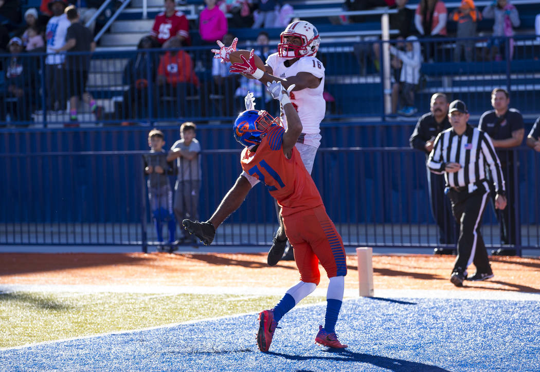 Liberty wide receiver Maurice Hampton (16) pulls in the ball in the end zone for a touchdown over Bishop Gorman's Ammonte Beverly (21) during the first half of the NIAA 4A Desert Region championsh ...