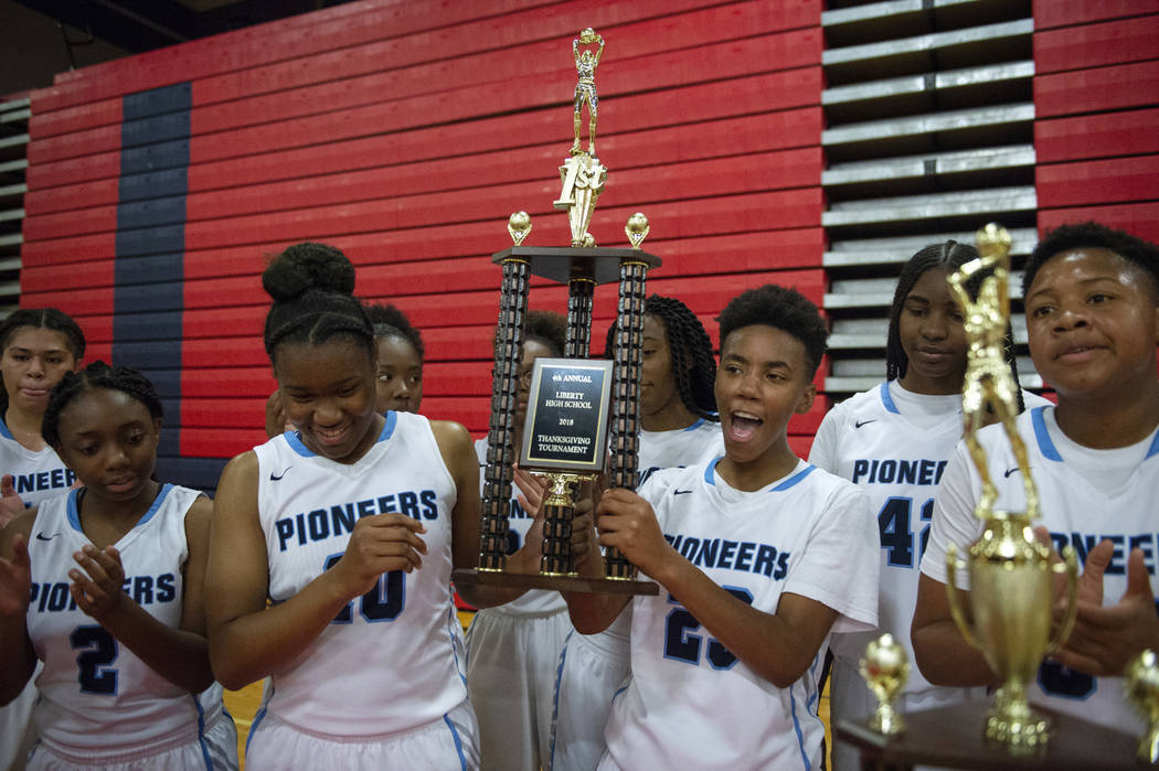 Canyon Springs holds its trophy after defeating Liberty during the second half of the Championship game of the Liberty Thanksgiving Invitational girls basketball tournament at Liberty High School ...