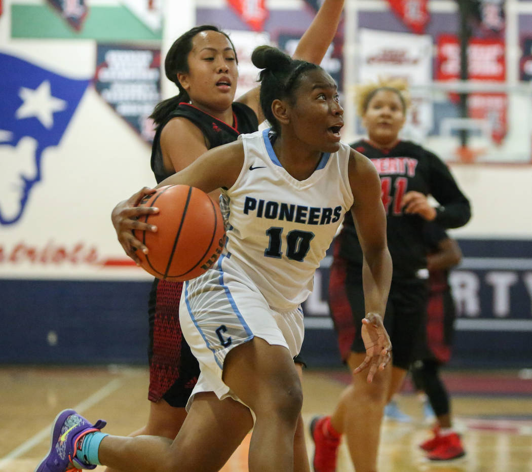 Canyon Spring's Sydnei Collier (10) runs down the court with the ball while under being guarded by Liberty's Tiana Tovia (1) during the second half of the Championship game of the Liberty Thanksgi ...