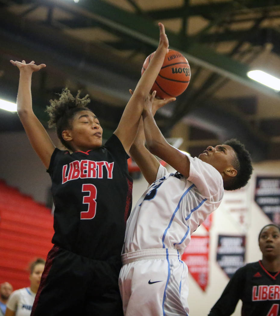 Canyon Springs' Kayla Johnson (23) jumps up with the ball while being guarded by Liberty's Journie Augmon (3) during the second half of the Championship game of the Liberty Thanksgiving Invitation ...