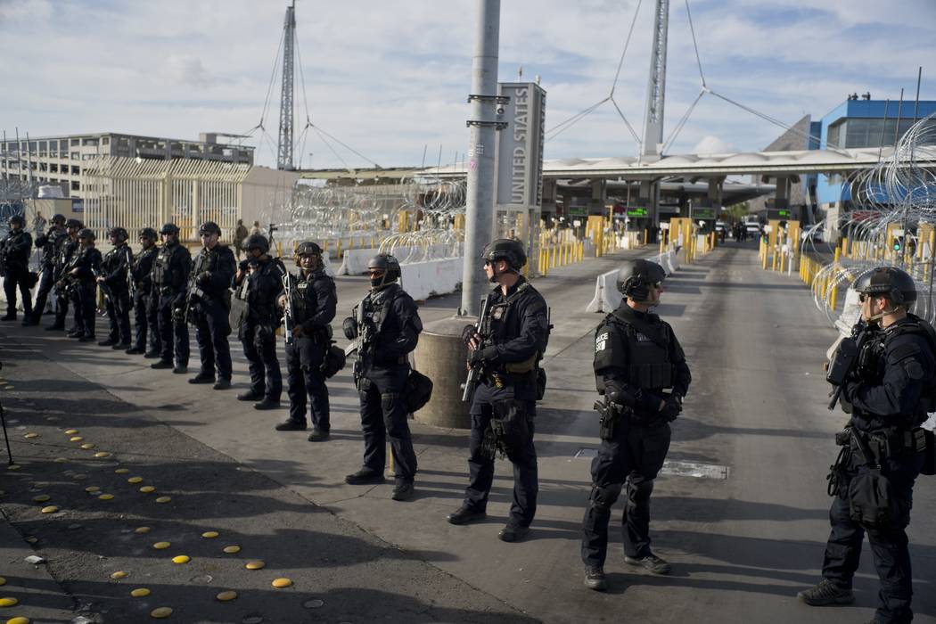 U.S. Customs and Border Protection agents stand guard at the San Ysidro port of entry on the U.S.-Mexico border, seen from Tijuana, Mexico, Thursday, Nov. 22, 2018. (AP Photo/Ramon Espinosa)
