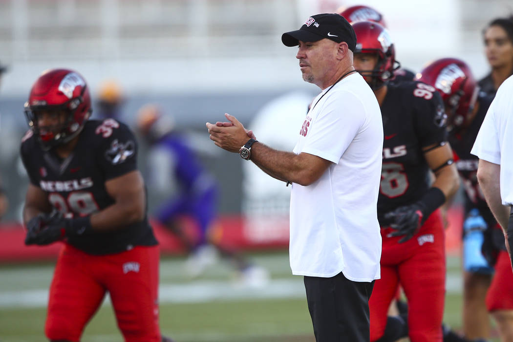 UNLV Rebels head coach Tony Sanchez watches as his players warm up before the start of a football game against Prairie View A&M Panthers at Sam Boyd Stadium in Las Vegas on Saturday, Sept. 15, 20 ...