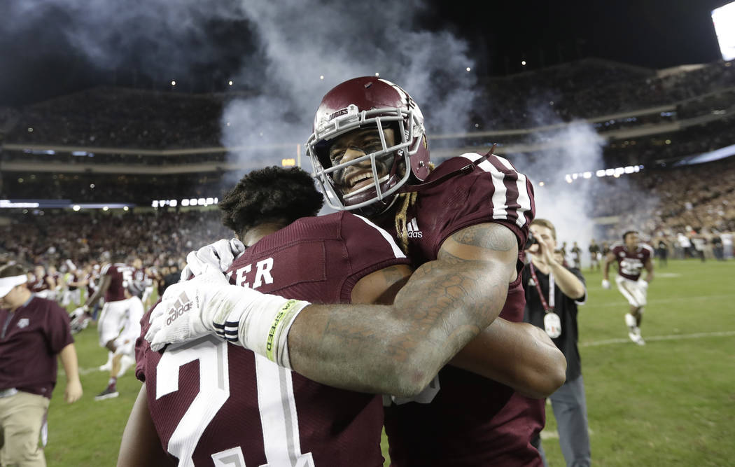 Texas A&M wide receiver Kendrick Rogers, right, celebrates with Charles Oliver (21) after an NCAA college football game against LSU Saturday, Nov. 24, 2018, in College Station, Texas. Texas A& ...